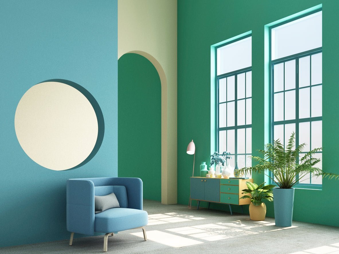 Modern interior with green walls, large windows, and a blue chair.